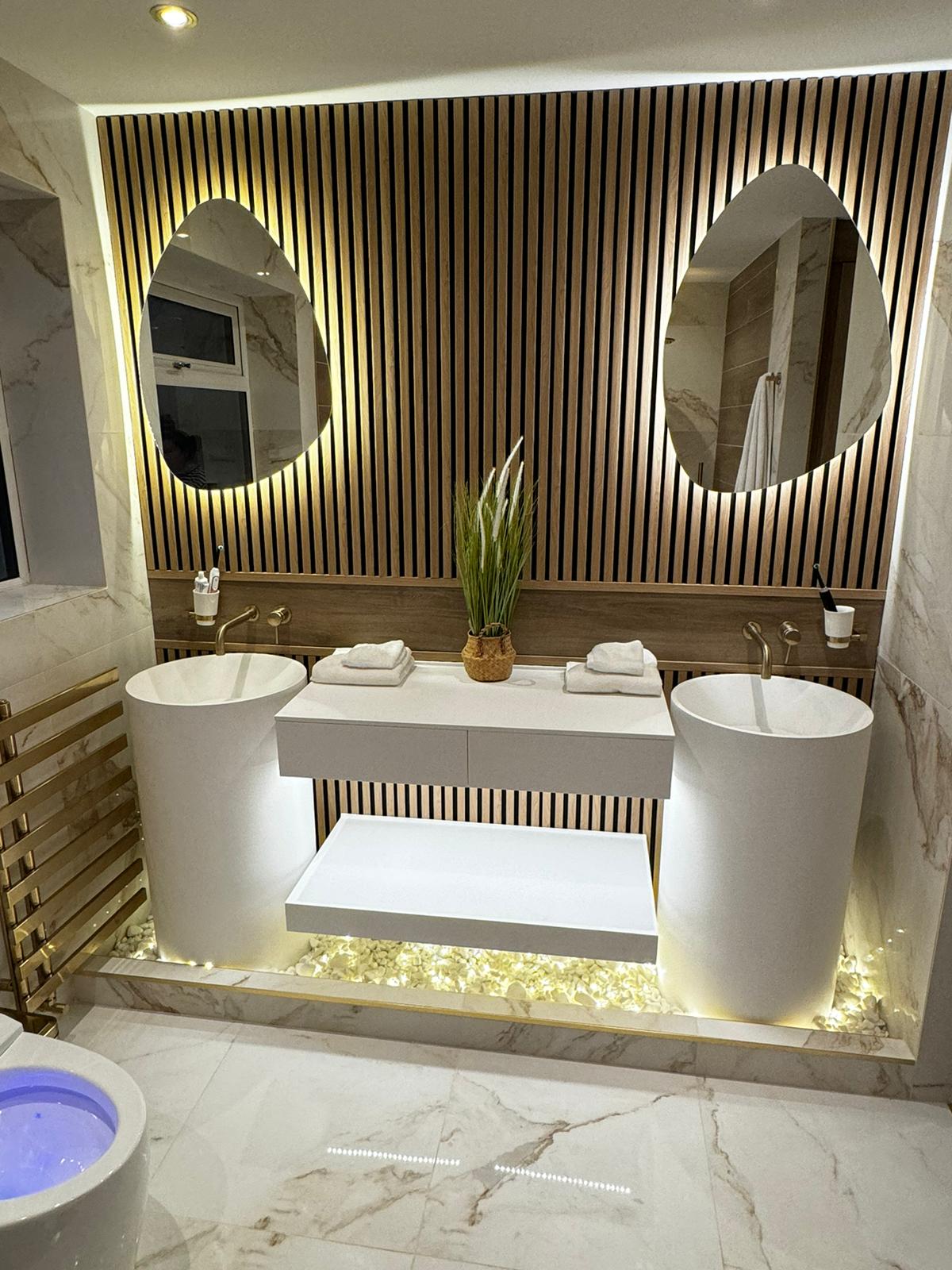 Illuminated twin basin bathroom with marble, timber and brass finishes