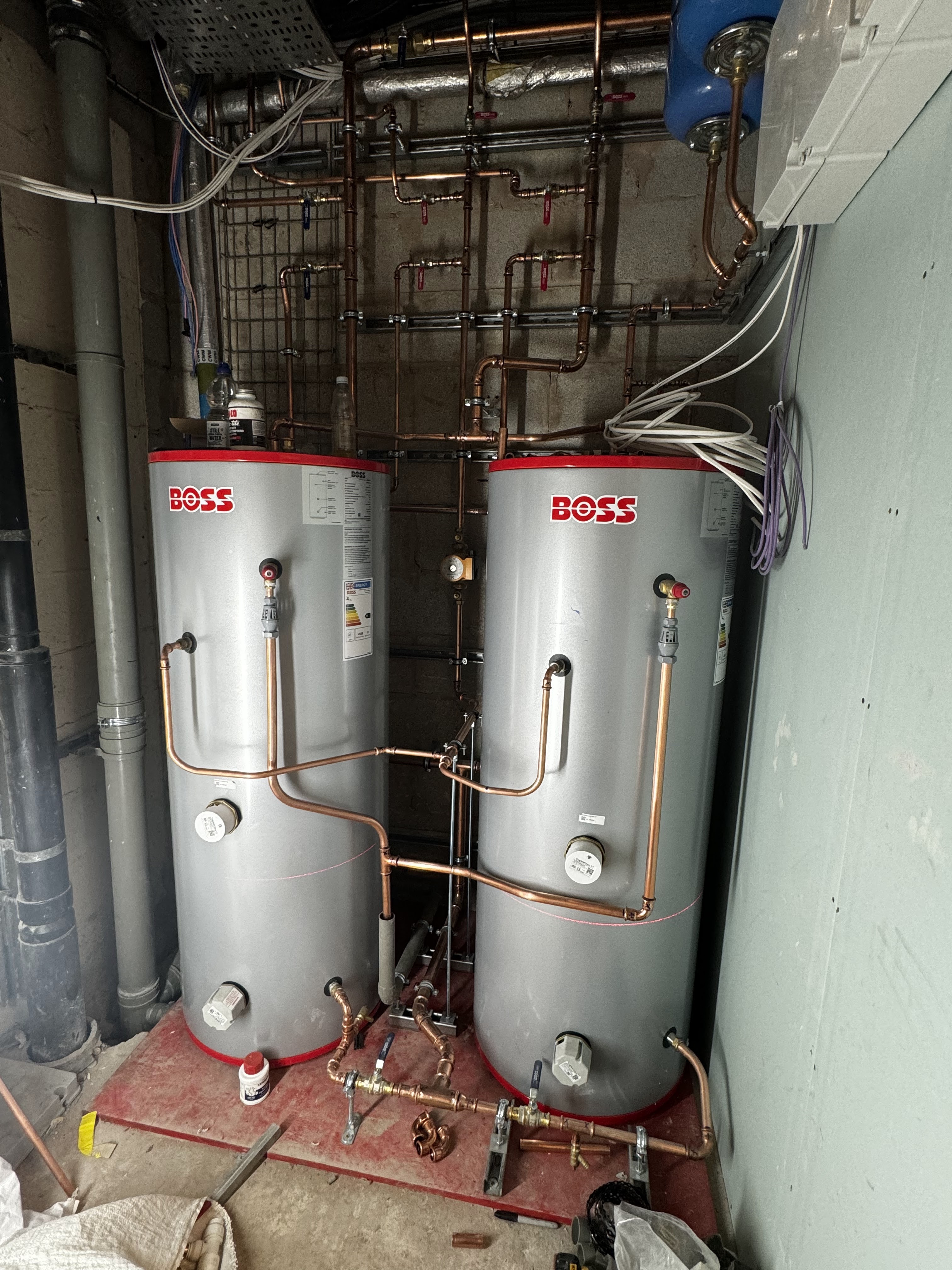 Hot water cylinder and associated pipework installation