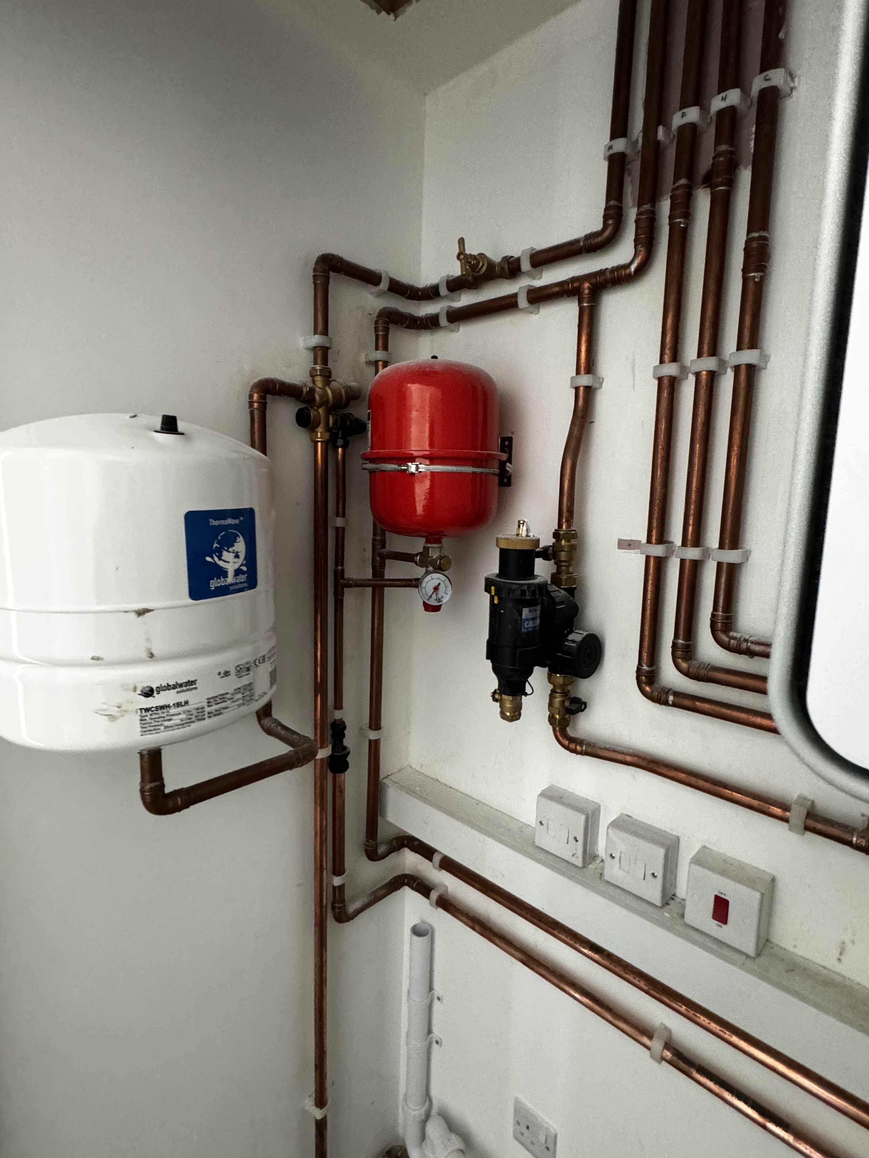 Heating system pipework and expansion vessel installation